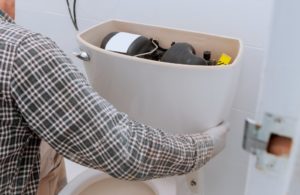 after hours plumber fixing a toilet